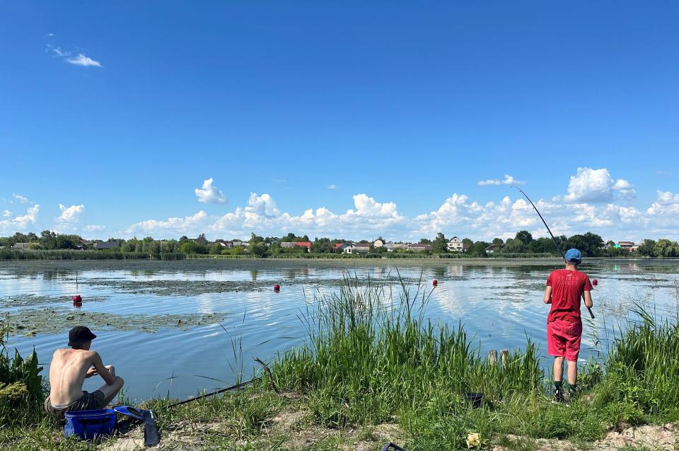 People fish, amid Russia’s attack on Ukraine, in the town of Starokostiantyniv in Khmelnytskyi region, western Ukraine (REUTERS)