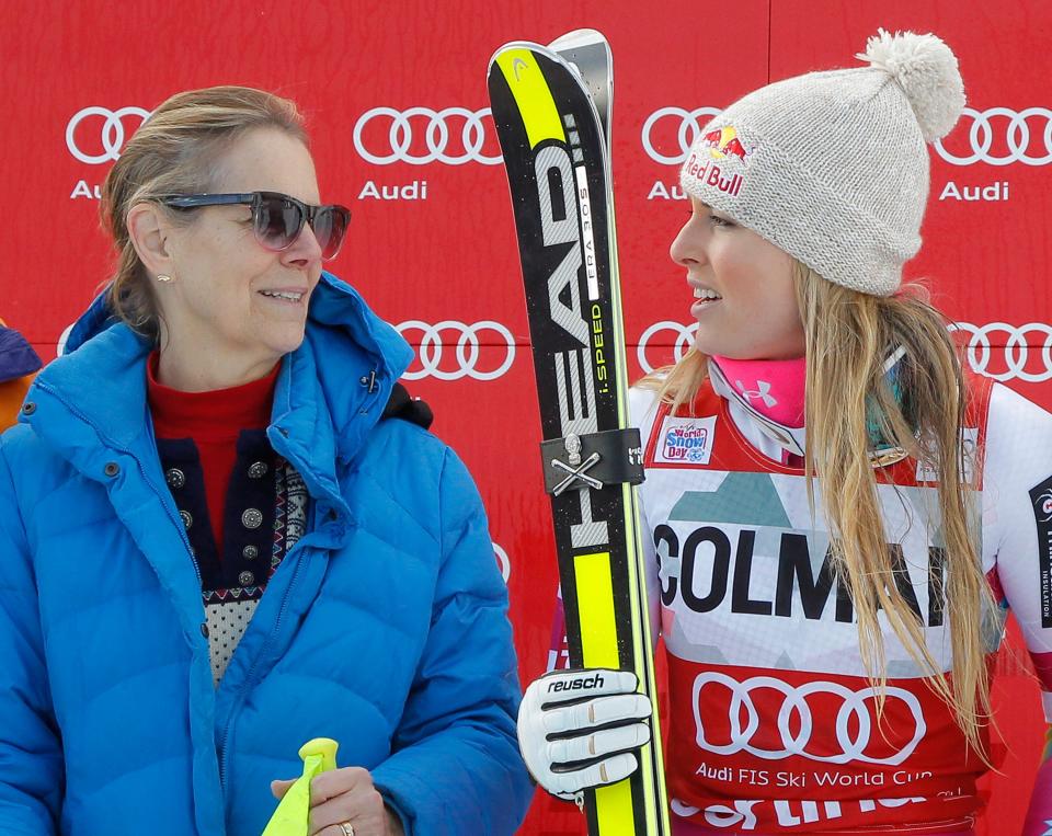 Lindsey Vonn looks at her mother Lindy while holding her skis