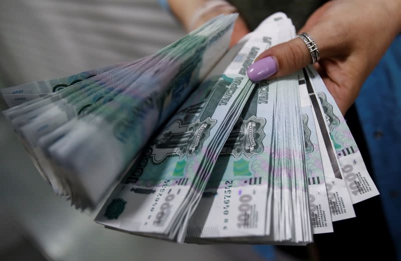 An employee holds 1000 Russian Roubles notes at Goznak printing factory in Moscow