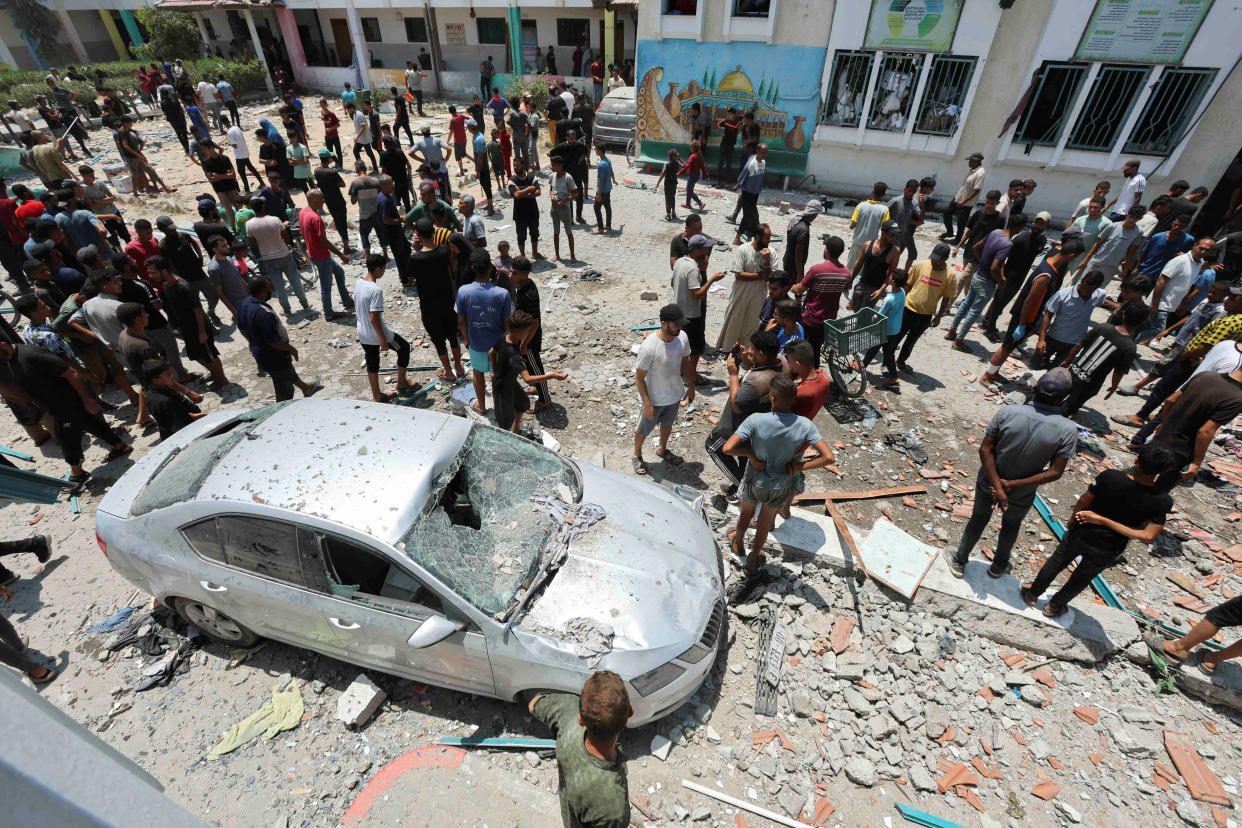 Palestinians inspect a school sheltering displaced people following an Israeli strike, amid Israel-Hamas conflict, in Deir Al-Balah in the central Gaza Strip, July 27, 2024. REUTERS/Ramadan Abed