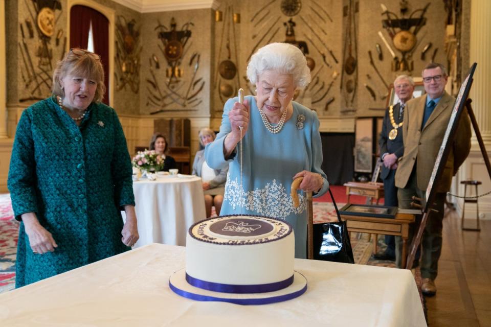 The Queen cutting a cake to celebrate the start of the Platinum Jubilee at Sandringham House (Joe Giddens/PA) (PA Wire)