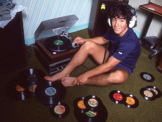 Diego Maradona at home with his record collection