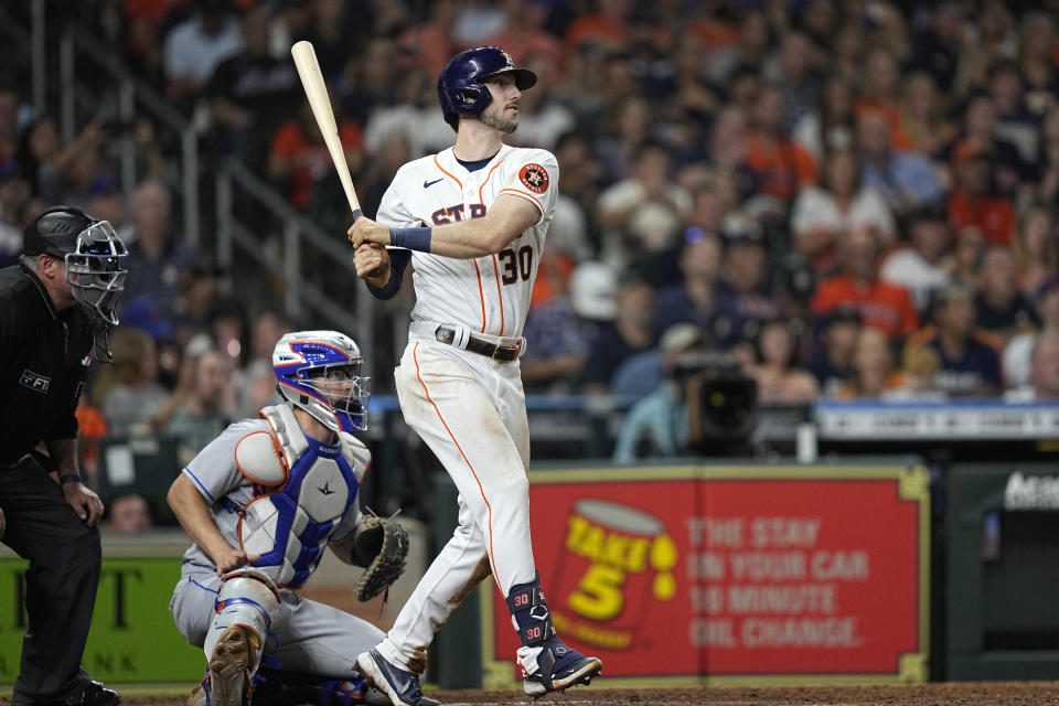 Houston Astros' Kyle Tucker (30) hits a three-run double as New York Mets catcher Patrick Mazeika watches during the fifth inning of a baseball game Tuesday, June 21, 2022, in Houston. (AP Photo/David J. Phillip)