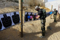 <p>An Israeli instructor hangs up balloons on shooting targets as a group of tourists take part in a two hour “boot camp” experience, at “Caliber 3 Israeli Counter Terror and Security Academy” in the Gush Etzion settlement bloc south of Jerusalem in the occupied West Bank July 13, 2017. (Photo: Nir Elias/Reuters) </p>