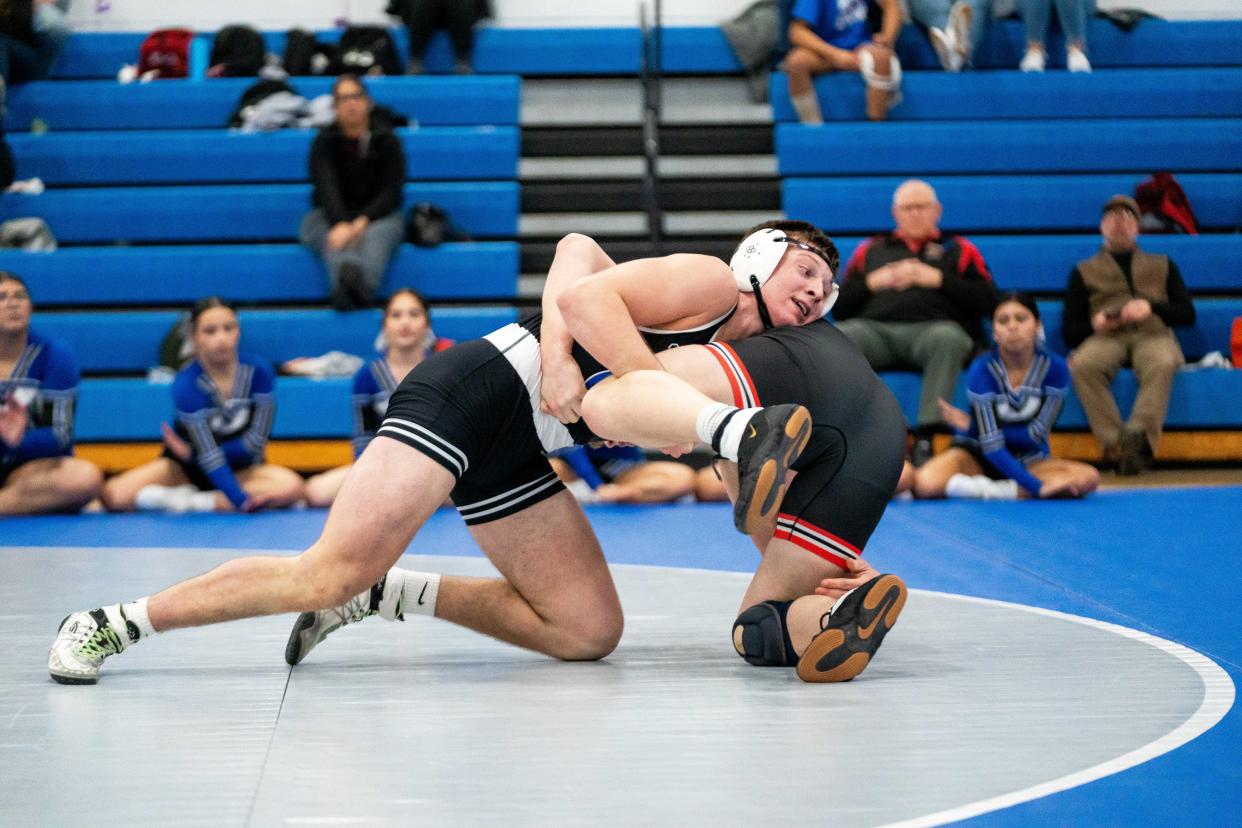 Perry's Kain Killmer wrestles with Roland-Story's Ian Tripp Tuesday, Jan. 30, 2024, at Perry High School.