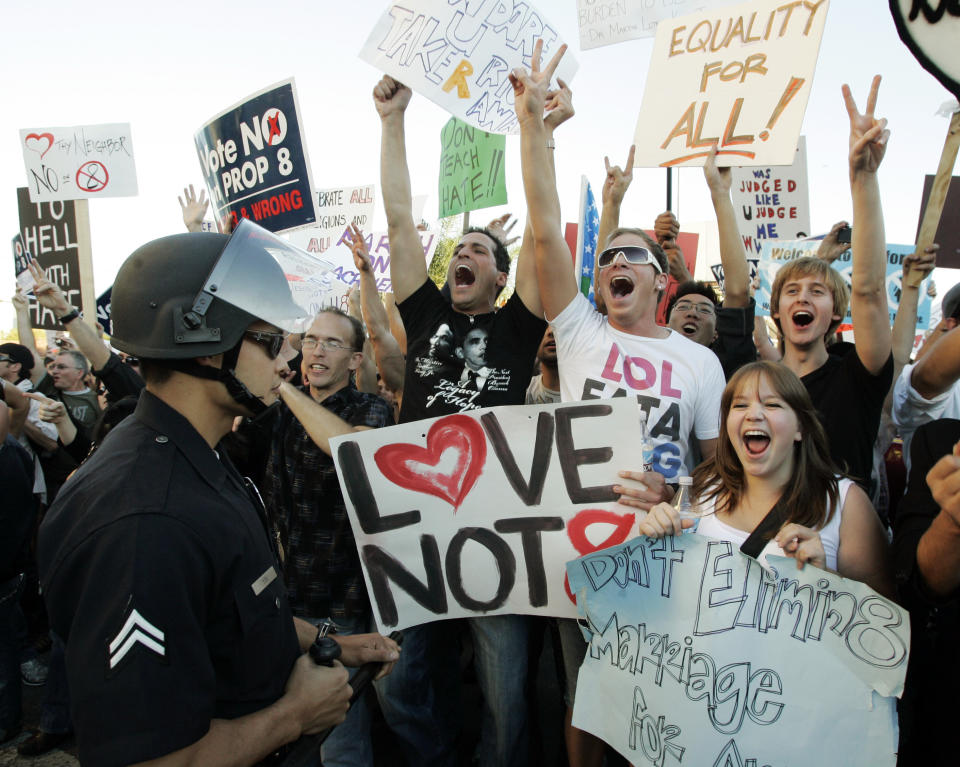 Protesters wait at a police skirmish line before being allowed to proceed as hundreds demonstrated against the Mormon Church's support of Proposition 8, the California ballot measure that banned same-sex marriage, in the Westwood district of Los Angeles Thursday, Nov. 6, 2008. Prop 8 was overturned in 2013. (AP Photo/Reed Saxon)