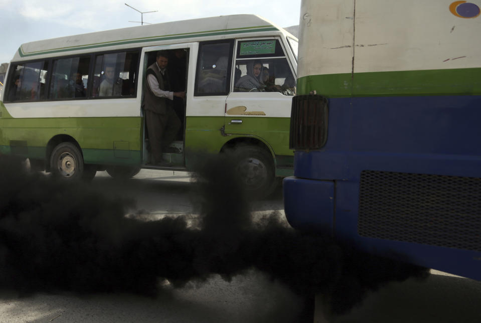 In this Oct. 16, 2019 photo, smoke comes out from the exhaust pipe of an old mini-bus in Kabul, Afghanistan. Authorities are trying to tackle pollution in the country’s capital, which may be even deadlier than 18-year-old war. Most days a layer of smog covers Kabul, and it gets worse in the winter, when people burn coal, garbage, plastic and rubber to heat their homes. (AP Photo/Rahmat Gul)