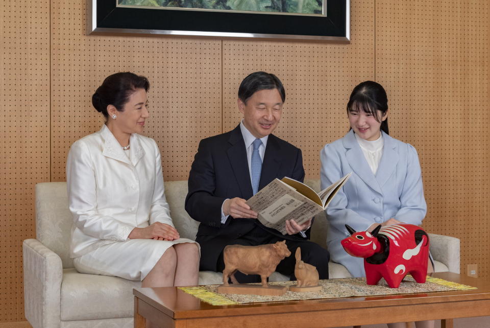 In this photo provided by the Imperial Household Agency of Japan, Japan's Emperor Naruhito, center, talks with her wife Empress Masako, left, and their daughter Princess Aiko during a family photo session for the New Year at their Akasaka Estate residence in Tokyo, in Tokyo, on Dec. 21, 2020. (The Imperial Household Agency of Japan via AP)