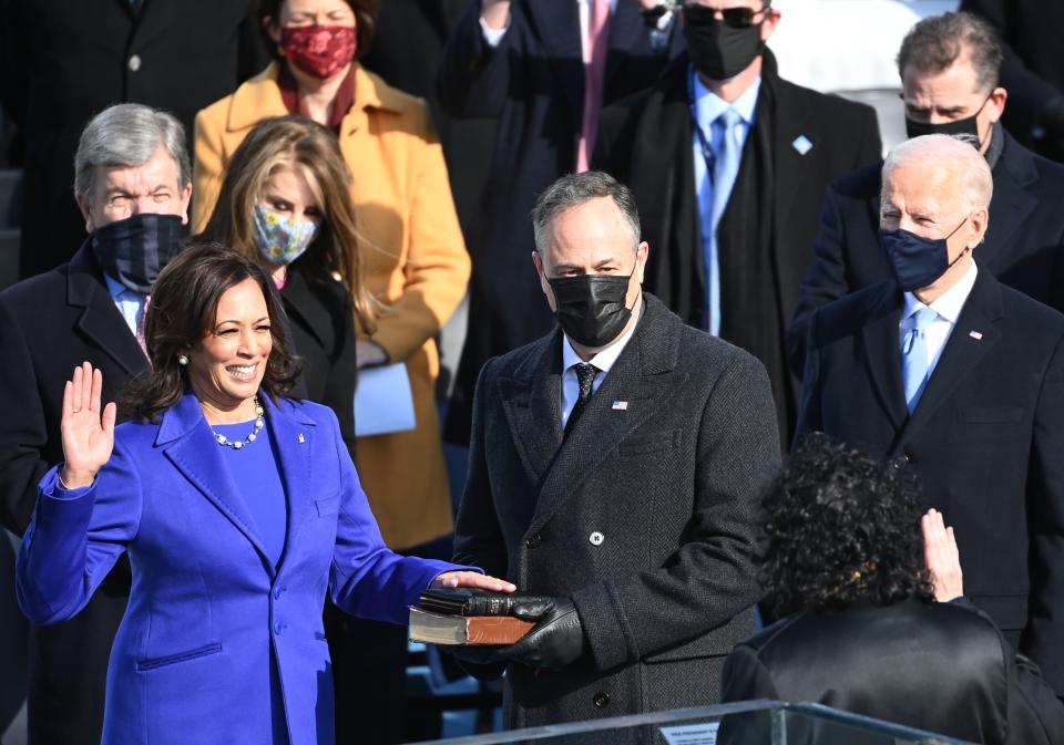 Kamala Harris, flanked by husband Doug Emhoff, is sworn in as the 49th US Vice President by Supreme Court Justice Sonia Sotomayor on January 20, 2021, at the US Capitol in Washington, DC. 