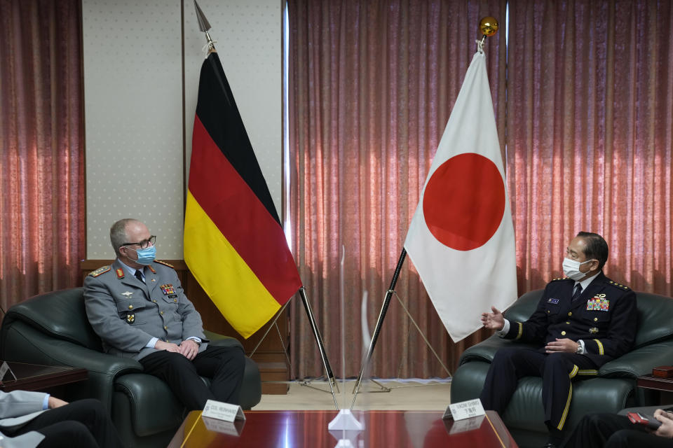 Gen. Koji Yamazaki, right, chief of Staff, Joint Staff of the Japan Self-Defense Forces, talks with Gen. Eberhard Zorn, chief of Defense of the German Armed Forces, at the Ministry of Defense in Tokyo, Friday, Nov. 5, 2021. (AP Photo/Hiro Komae)