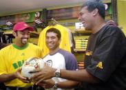 BANGALORE, INDIA: Tennis players Leander Paes (L) and Mahesh Bhupati (R) share a joke with ace Indian cricketer Sachin Tendulkar (C) at a function in Bangalore 17 December 2001 to launch the official match ball for the 2002 Soccer World Cup, "Fevernova". The three sportsmen are the Indian brand ambassadors for adidas, the official sponsor of the 2002 World Cup. It has become common among Indian sportspersons to endorse commercial products to supplement their income. AFP PHOTO/INDRANIL MUKHERJEE (Photo credit should read INDRANIL MUKHERJEE/AFP/Getty Images)