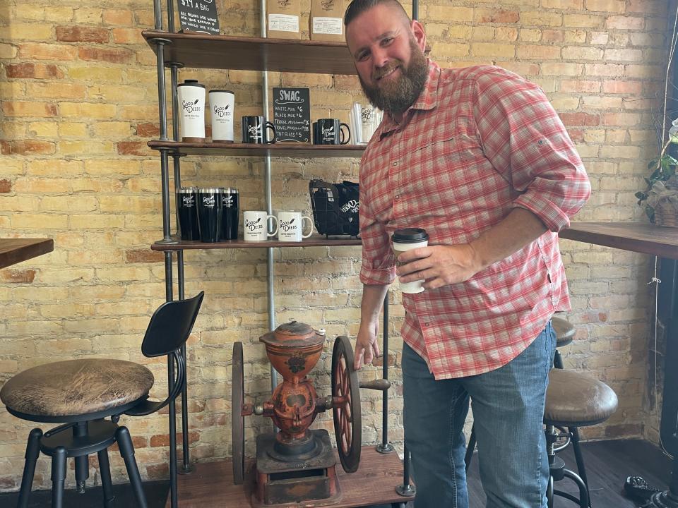 Brandon Denby shows off an antique coffee grinder that was once at Pearce’s Store of Oak Grove on Monday, July 31, 2023.