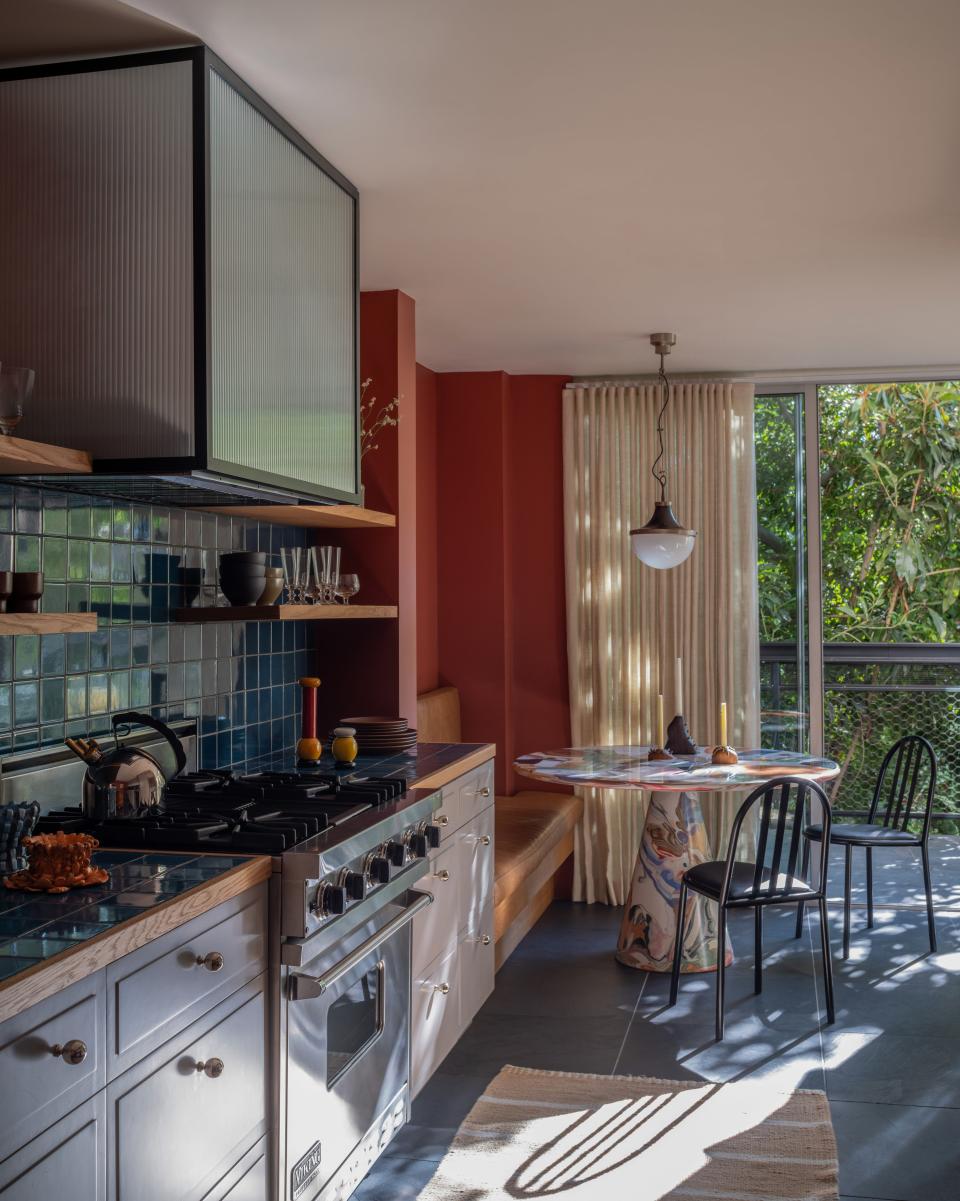 The kitchen’s galley layout holds a mirror to its midcentury past. Neda and Zabie brightened up the counter and backsplash with handmade Heath ceramic tiles. The cabinets wear Farrow & Ball’s Pavilion Gray, while the hood bears a likeness to late Italian architect Lina Bo Bardi’s iconic Casa de Vidro in São Paulo, Brazil.