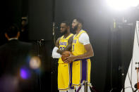 Los Angeles Lakers forwards LeBron James, center left, and Anthony Davis, center right, pose for photos during the NBA basketball team's media day in El Segundo, Calif., Friday, Sept. 27, 2019. (AP Photo/Ringo H.W. Chiu)