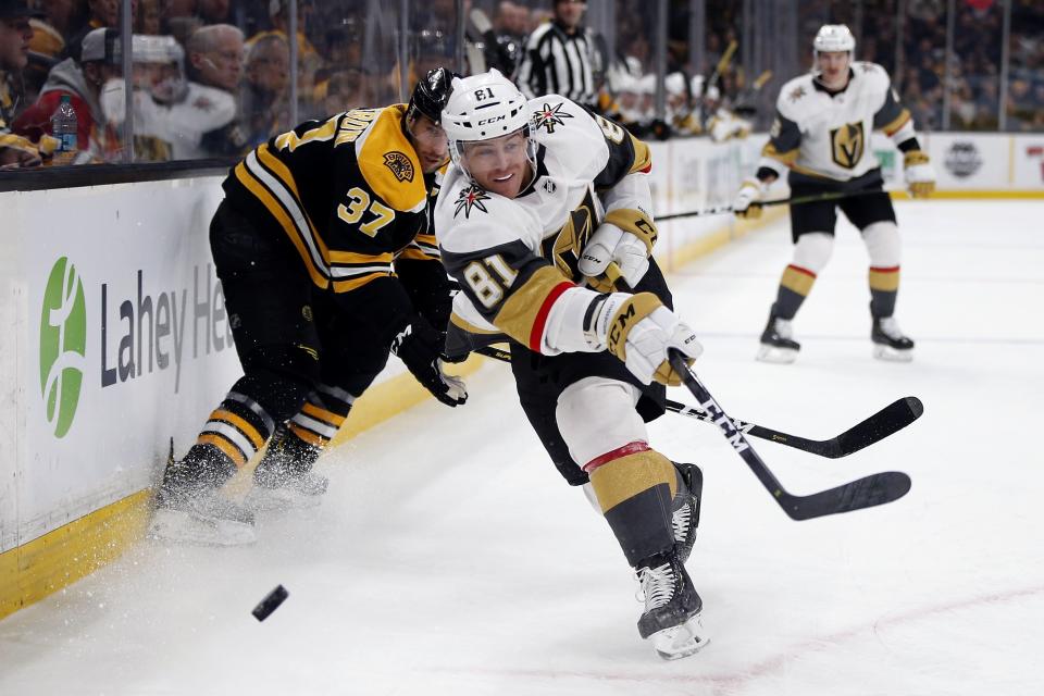 <p>
              Vegas Golden Knights' Jonathan Marchessault (81) sends the puck along the boards in front of Boston Bruins' Patrice Bergeron (37) during the first period of an NHL hockey game in Boston, Sunday, Nov. 11, 2018. (AP Photo/Michael Dwyer)
            </p>