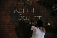A man writes the name of Keith Scott during a protest against the police shooting of Scott in Charlotte, North Carolina, U.S. September 23, 2016. REUTERS/Jason Miczek