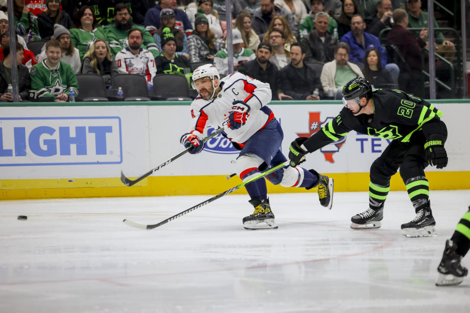 Washington Capitals left wing Alex Ovechkin (8) shoots as Dallas Stars defenseman Ryan Suter (20) defends during the second period of an NHL hockey game, Saturday, Jan. 27, 2024, in Dallas. (AP Photo/Gareth Patterson)