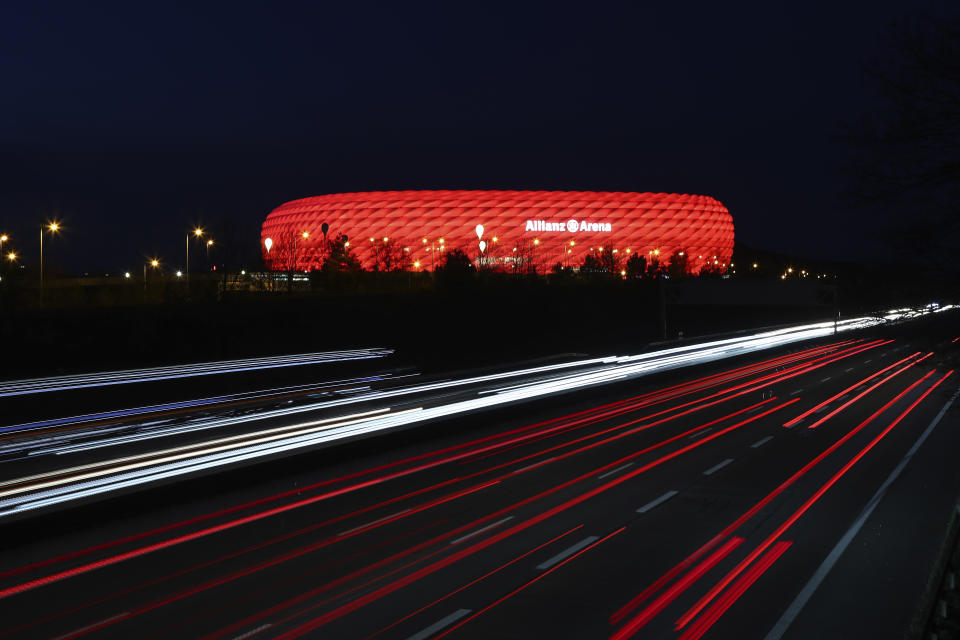 FILE - In this Monday, March 16, 2020 file photo, cars pass the illuminated 'Allianz Arena' soccer stadium in Munich, Germany. Hungary may play its final group game at the European Championship in a stadium lit up in rainbow colors. Munich Mayor Dieter Reiter said Sunday June 20, 2021, he was going to write to UEFA to ask for permission for Germany’s stadium to be lit up with the colors as a sign against homophobia and intolerance when the team plays Hungary on Wednesday. (AP Photo/Matthias Schrader, File)