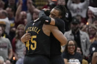 Cleveland Cavaliers guard Darius Garland, right, hugs teammate Donovan Mitchell (45) after hitting a 3-point basket in the second half of Game 7 of an NBA basketball first-round playoff series against the Orlando Magic, Sunday, May 5, 2024, in Cleveland. (AP Photo/Sue Ogrocki)