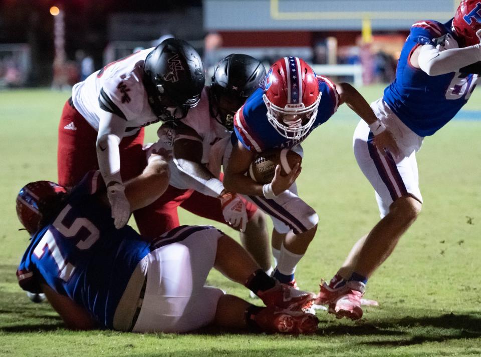 Quarterback Nick Simmons (10) keeps the ball and takes it to just short of the goal line to set up 2nd and goal during the West Florida vs Pace football game at Pace High School on Friday, Sept. 9, 2022.