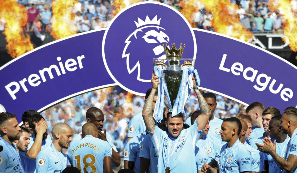 Manchester City’s goalkeeper Ederson Moraes lifts the English Premier League trophy after the soccer match between Manchester City and Huddersfield Town at Etihad stadium in Manchester, England on 6 May, 2018. (PHOTO: AP/Rui Vieira)