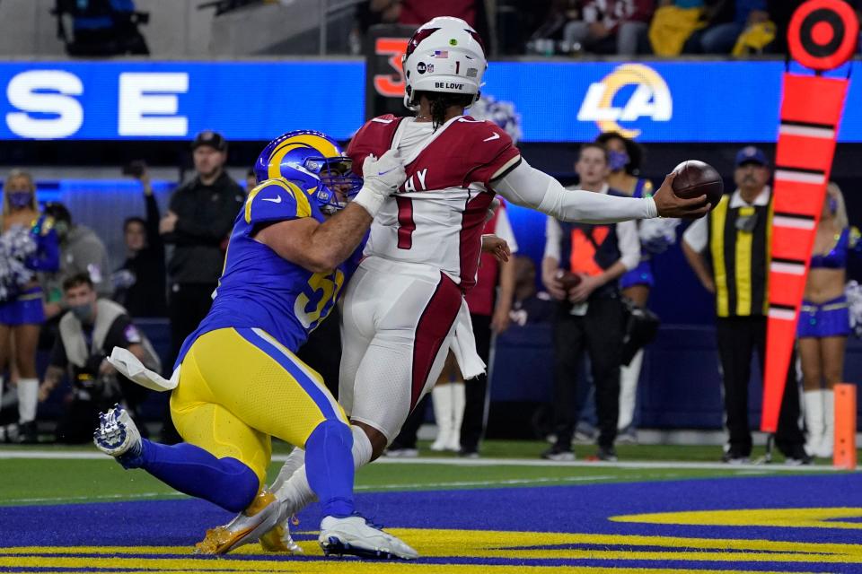 Los Angeles Rams inside linebacker Troy Reeder, left, pressures Arizona Cardinals quarterback Kyler Murray (1) into throwing a pass that was intercepted and returned for a touchdown by David Long Jr. during the first half of an NFL wild-card playoff football game in Inglewood, Calif., Monday, Jan. 17, 2022. (AP Photo/Mark J. Terrill)