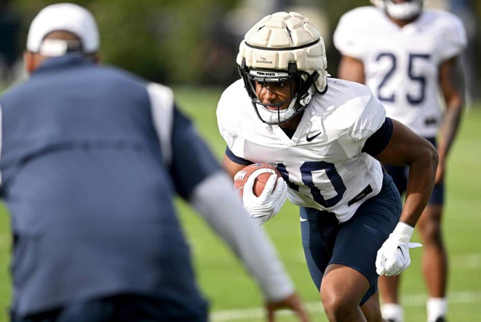Penn State running back Nick Singleton runs a drill during practice on Wednesday, Aug. 30, 2023.  