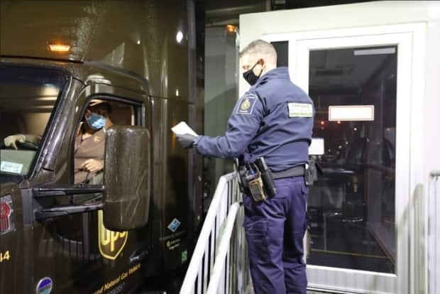 A truck carrying COVID-19 vaccine crosses the Canada-U.S. border into B.C. on Monday, Dec. 12, 2020.