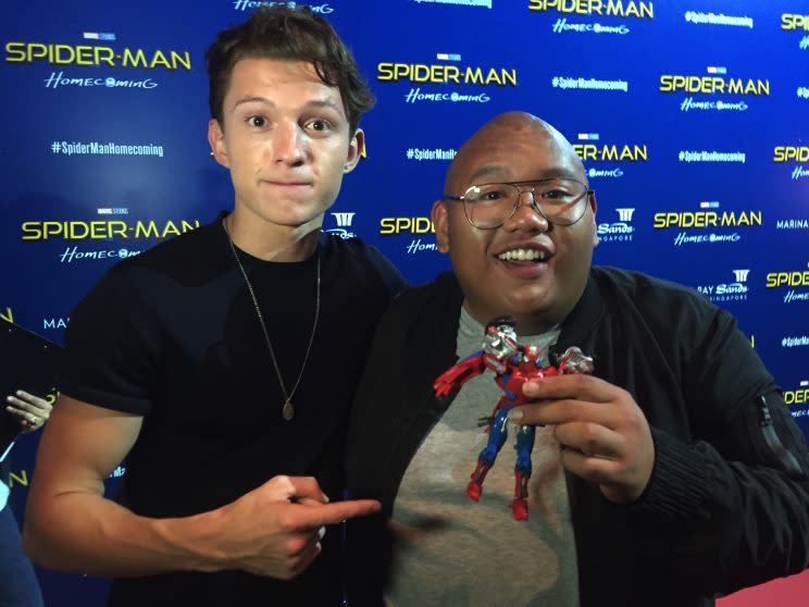 Tom Holland and Jacob Batalon and a Spider-Man Transformer.