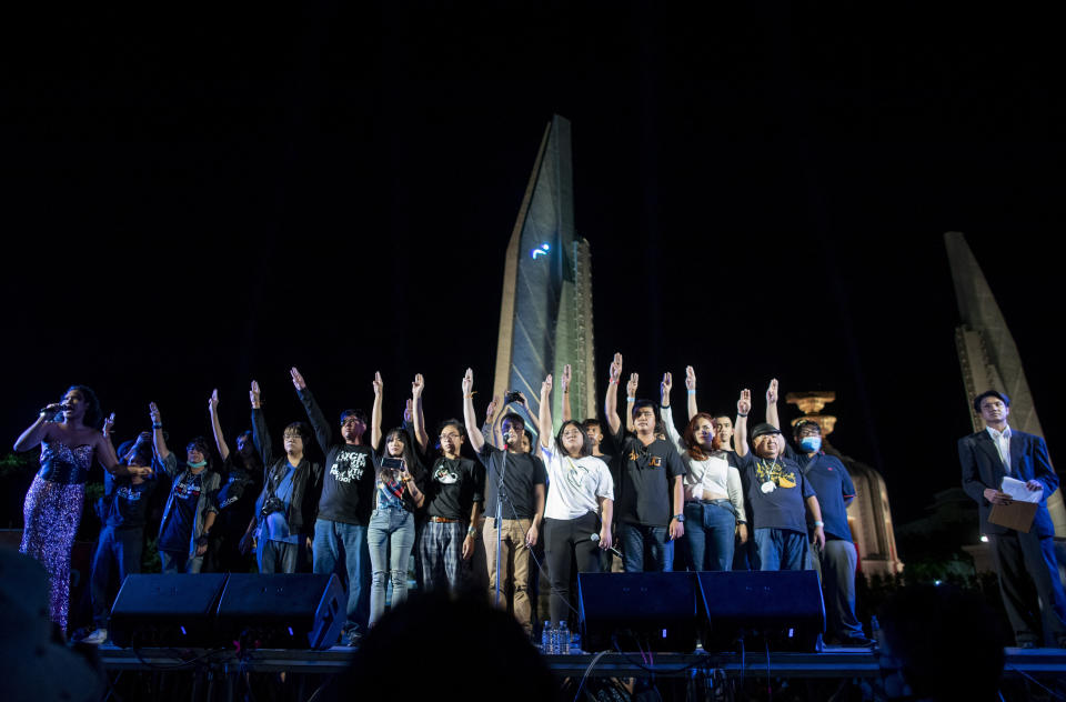 Pro-democracy activist and student leaders raise a three-fingers salute, a symbol of resistance after a protest rally at Democracy Monument in Bangkok, Thailand, Sunday, Aug. 16, 2020. A two-day rally planned for this weekend is jangling nerves in Bangkok, with apprehension about how far student demonstrators will go in pushing demands for reform of Thailand’s monarchy and how the authorities might react. More than 10,000 people are expected to attend the Saturday-Sunday event. (AP Photo/Gemunu Amarasinghe)