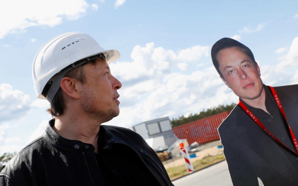 SpaceX founder and Tesla CEO Elon Musk looks at a cutout of him as he visits the construction site of Tesla's gigafactory in Gruenheide, near Berlin, Germany, May 17, 2021. REUTERS/Michele Tantussi - RC2PHN9W61UA