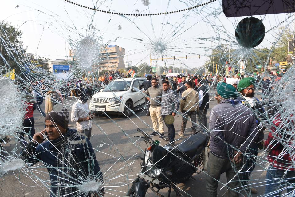 NEW DELHI, INDIA - JANUARY 26: A DTC bus damaged during violence after farmers on tractors entered the city on Republic Day at ITO on January 26, 2021 in New Delhi, India. Major scenes of chaos and mayhem at Delhi borders as groups of farmers allegedly broke barricades and police check posts and entered the national capital before permitted timings. Police used tear gas at Delhi's Mukarba Chowk to bring the groups under control. Clashes were also reported at ITO, Akshardham. Several rounds of talks between the government and protesting farmers have failed to resolve the impasse over the three farm laws. The kisan bodies, which have been protesting in the national capital for almost two months, demanding the repeal of three contentious farm laws have remained firm on their decision to hold a tractor rally on the occasion of Republic Day.(Photo by Arvind Yadav/Hindustan Times via Getty Images)