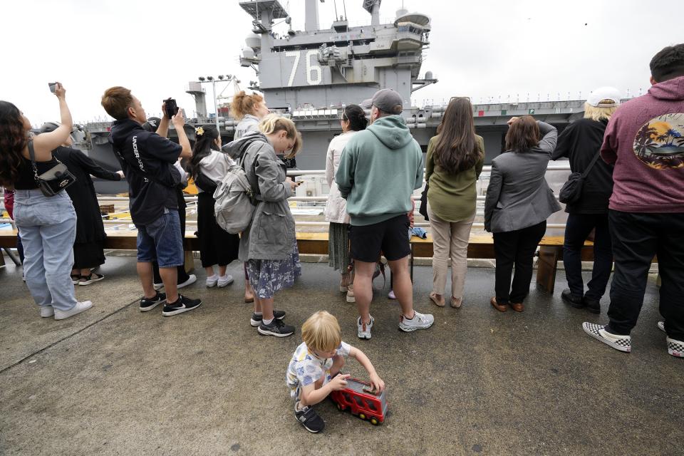 Family members and friends of the crew of the U.S. navy aircraft carriers USS Ronald Reagan (CVN-76) see off at the U.S. navy's Yokosuka base Thursday, May 16, 2024, in Yokosuka, south of Tokyo. This is the ship's final departure from Yokosuka before transiting back to the United States. (AP Photo/Eugene Hoshiko)