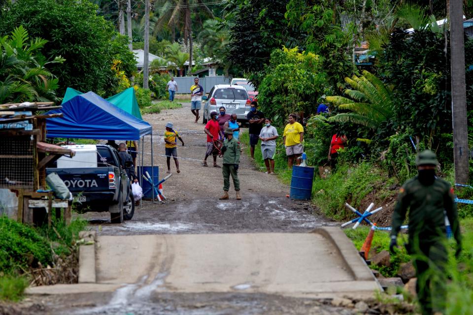 Police patrol a residential area to check people are wearing face masks in Suva on July 3, as a worsening Covid-19 outbreak overwhelms the South Pacific nation's largest hospital. Source: AFP via Getty Images)