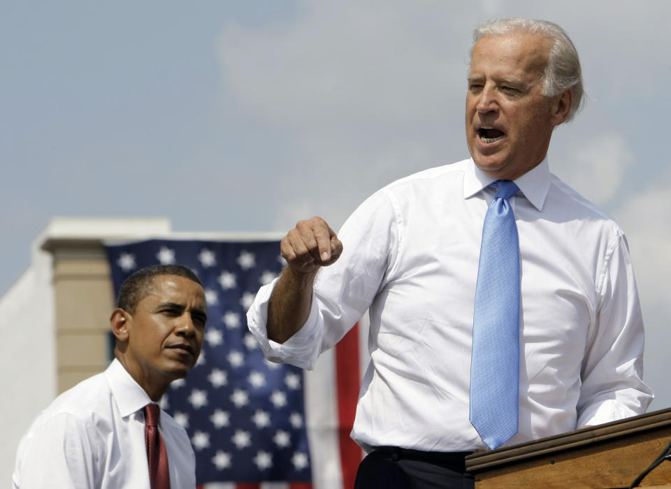 FILE - In this Aug. 23, 2008, file photo Democratic presidential candidate Sen. Barack Obama, D-Ill., listens as vice presidential running mate Sen. Joe Biden, D-Del., speaks at a rally in front of the Old State Capitol in Springfield, Ill. Biden has won the last few delegates he needed to clinch the Democratic nomination for president. (AP Photo/Alex Brandon, File)