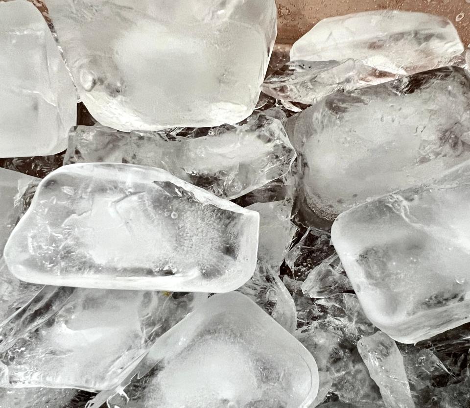 A close-up view of the frozen bubbles trapped in the ice of a pond.