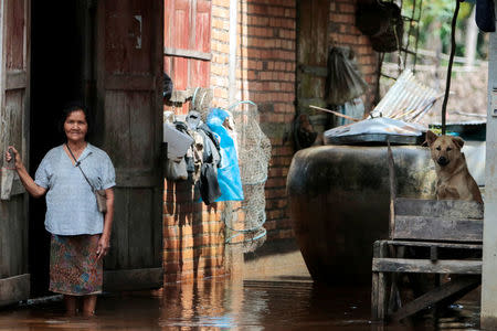 Reang On-nuan stands next to her flooded house at Cha-uat district in Nakhon Si Thammarat Province, southern Thailand, January 18, 2017. REUTERS/Surapan Boonthanom