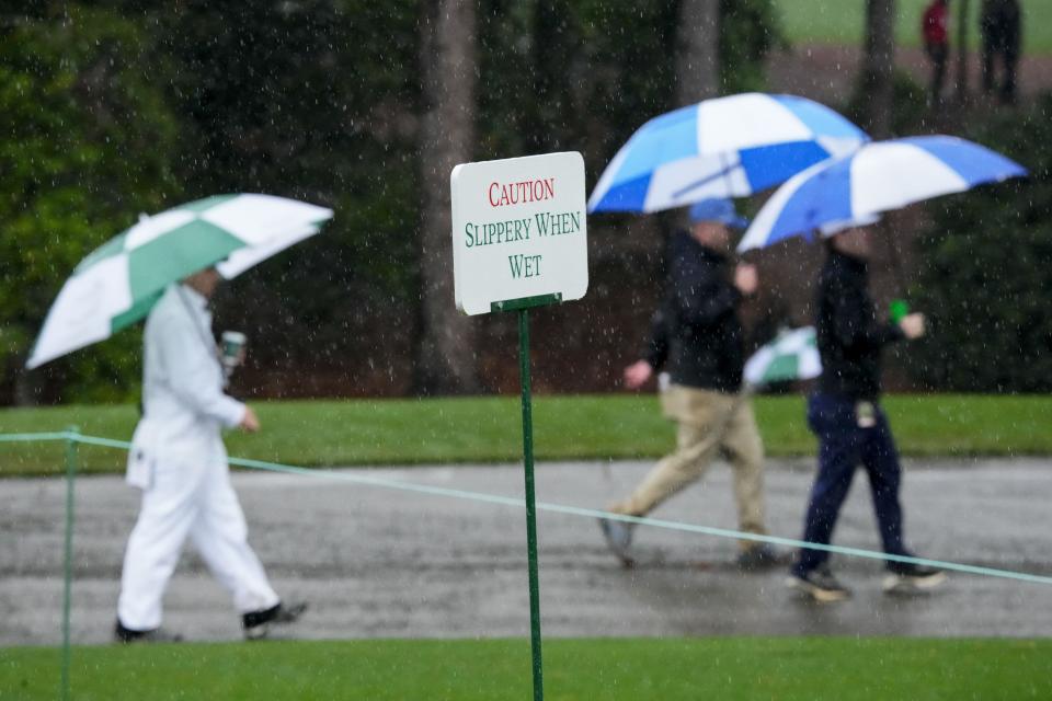 FILE - Apr 8, 2023; Augusta, Georgia, USA; Patrons carry umbrellas to be sheltered from the rain during the third round of The Masters golf tournament. Mandatory Credit: Rob Schumacher-USA TODAY Network