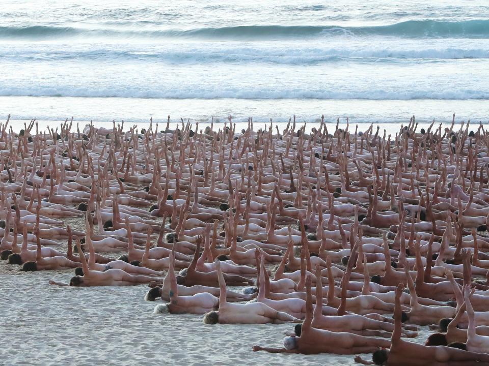 Group of nude people on Bondi Beach for cancer awareness photo shoot