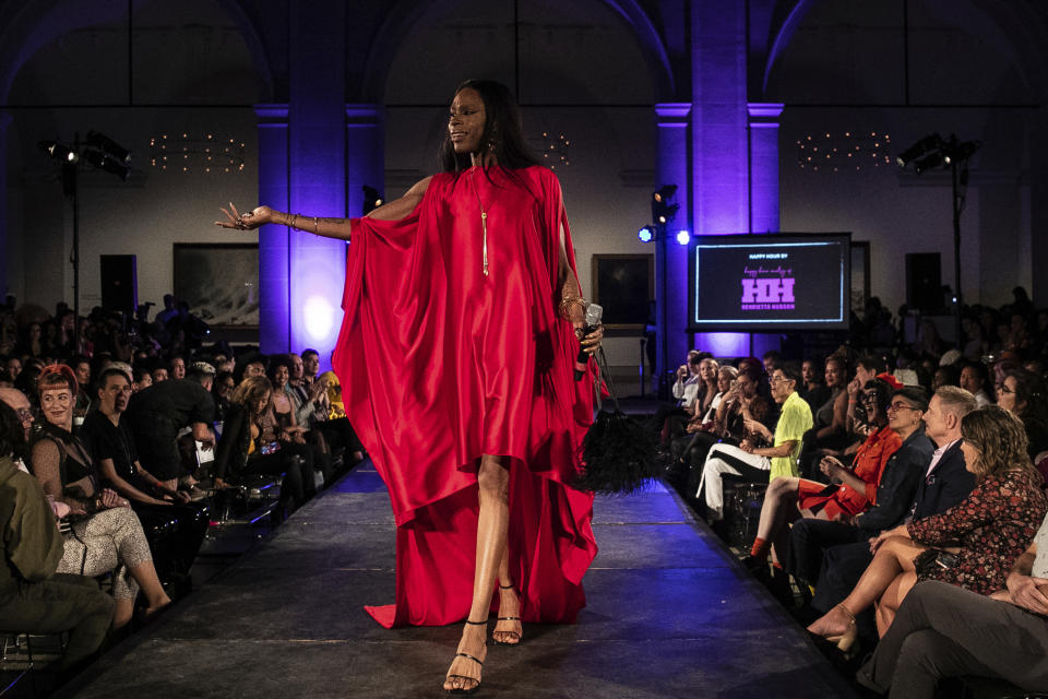 Red carpet host B. Hawk Snipes stands on the stage during dapperQ fashion show at the Brooklyn Museum on Thursday, Sept. 5, 2019, in New York. (AP Photo/Jeenah Moon)