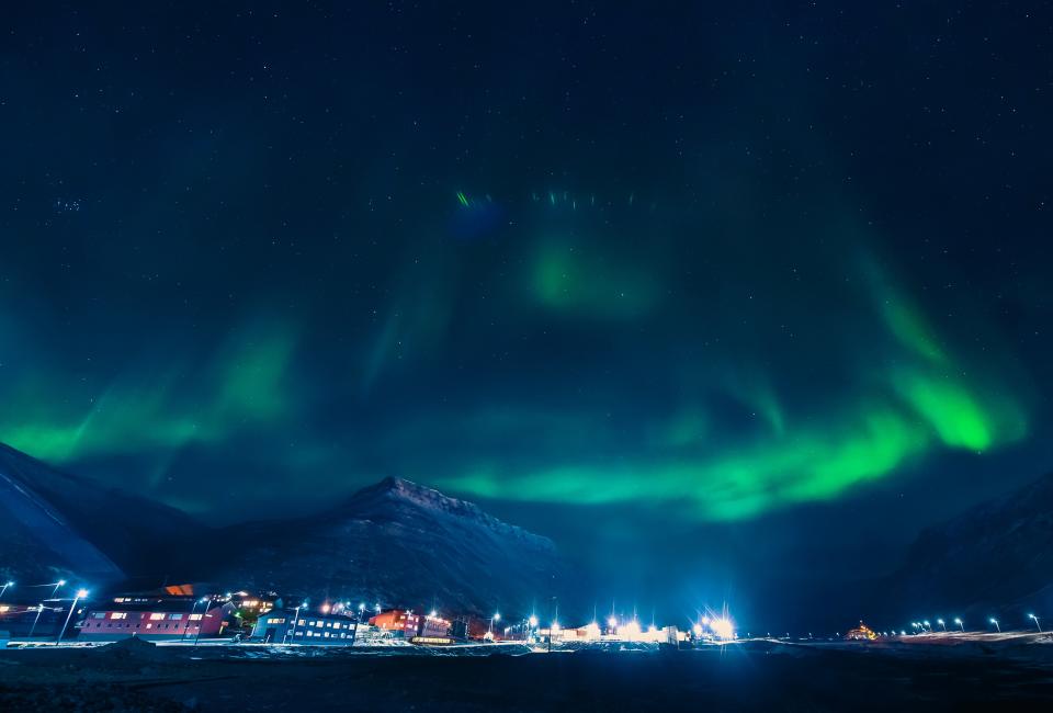 <h1 class="title">The polar arctic Northern lights aurora borealis sky star in Norway Svalbard in Longyearbyen city the moon mountains</h1><cite class="credit">Photo by Bublik Polina. Image courtesy of Getty.</cite>