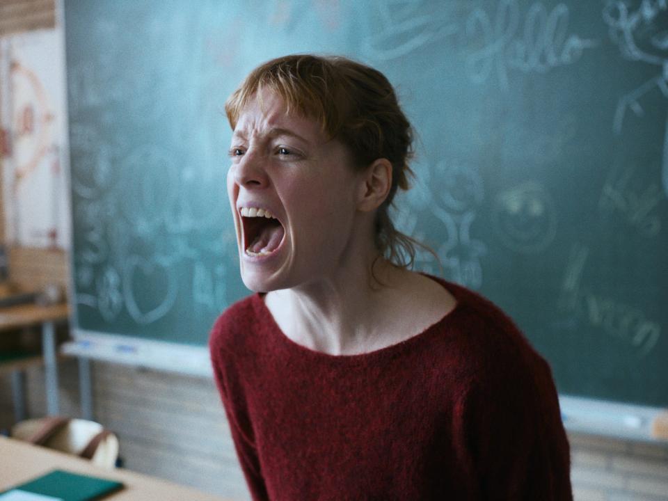 A teacher screams in a classroom in front of a chalkboard in a still from "The Teachers' Lounge."