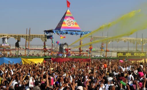 Indian Sant Asaram Bapu (centre) plays Holi with his followers during the Kumbh Mela festival in Allahabad on March 9, 2013. A record number of 120 million pilgrims have cleansed off their sins after taking a dip in an Indian river during the two-month-long Kumbh Mela festival that draws to an end on March 10