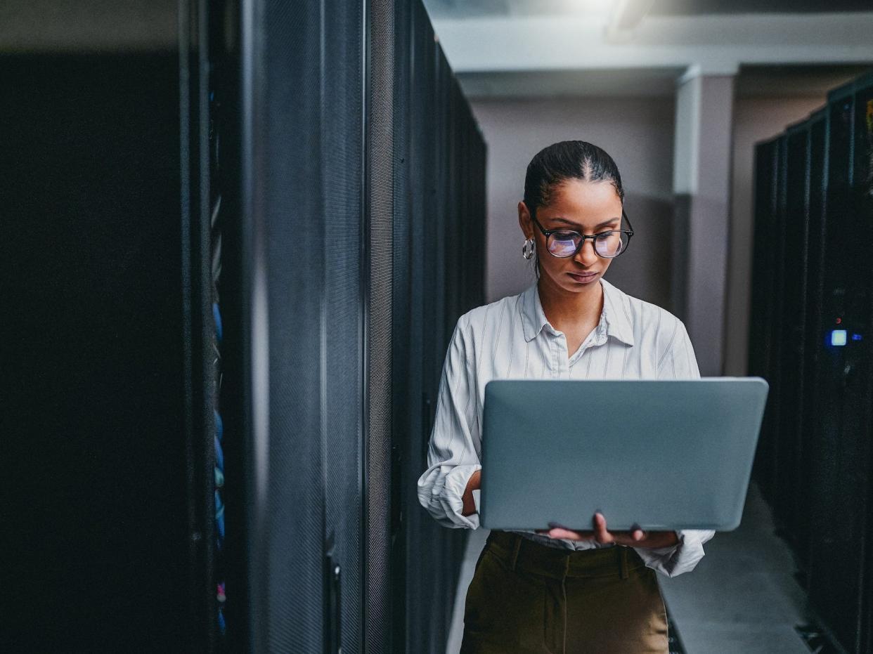 Tech worker holding a laptop