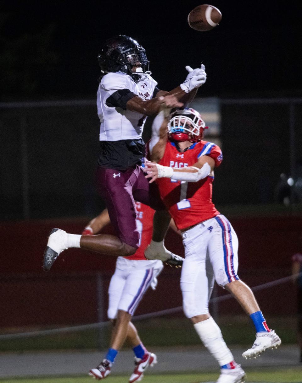 Navarre's Terence Marshall (No. 1) comes up short in the end zone as Pace's Carson Lowe (No. 7) defends against the air ball during Friday night's District 1-4S game between the Patriots and the Raiders.