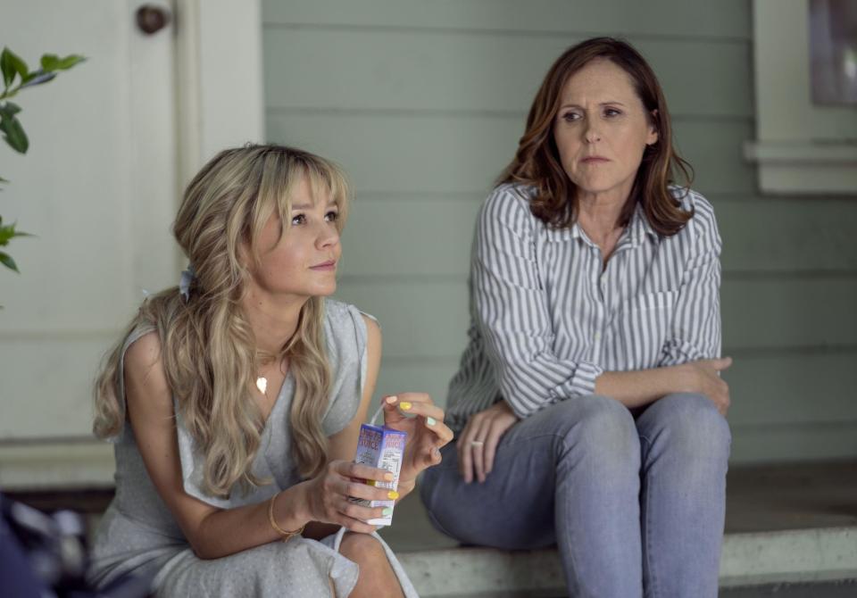 Carey Mulligan drinks a juice box as she talks with Molly Shannon on a front porch