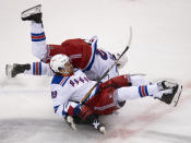 New York Rangers right wing Pavel Buchnevich (89) and defenseman Brendan Smith (42) knock Carolina Hurricanes center Martin Necas (88) to the ice during the first period in the NHL hockey Stanley Cup playoffs in Toronto, Saturday, Aug. 1, 2020. (Frank Gunn/The Canadian Press via AP)