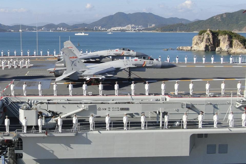 China's new Shandong aircraft carrier with sailors lined up