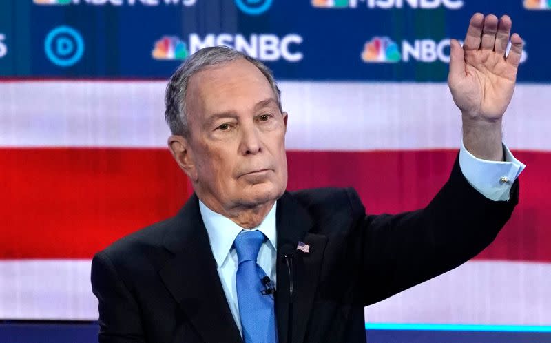 Former New York City Mayor Bloomberg raises his hand to speak during the ninth Democratic 2020 U.S. presidential debate at the Paris Theater in Las Vegas, Nevada, U.S.,