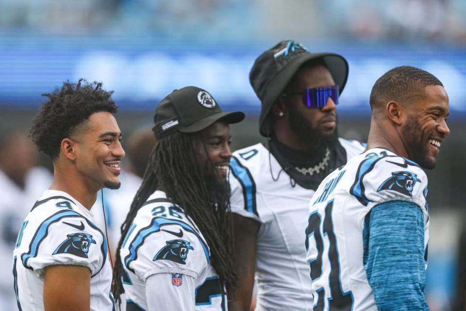 Panthers players, Bryce Young, left, Donte Jackson, Brian Burns and Jeremy Chinn, right, share a laugh on the sideline during the pre-season game against the Jets at Bank of America Stadium on Saturday, August 12, 2023 in Charlotte, NC.